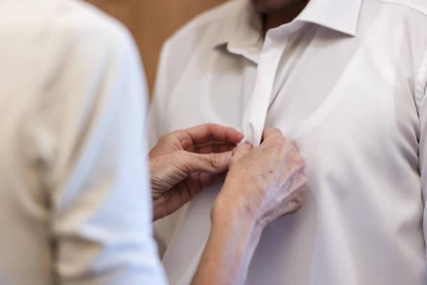 istock Close Up Of a Mother Helping Her Son Getting Ready For The Wedding 1820165489