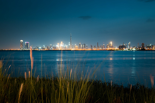 Capturing the enchanting blue hour at Dubai Creek Harbour, this image showcases the city's downtown in a serene and captivating light. The modern skyline is beautifully illuminated, creating a magical atmosphere that defines the essence of this vibrant urban hub of United Arab Emirates