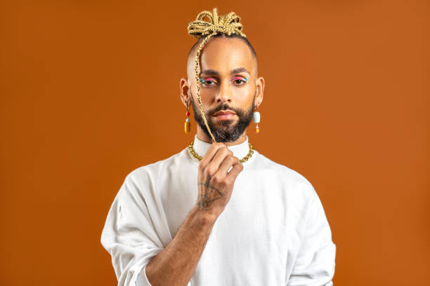 istock Black latin gay man with make up isolated on orange background 1820195509