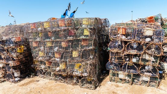 Prawn and shrimp traps at the fishing port of Essaouira, Morocco. Fishermen strategically place the prawn traps on the ocean floor, often baiting them to attract the prawns.