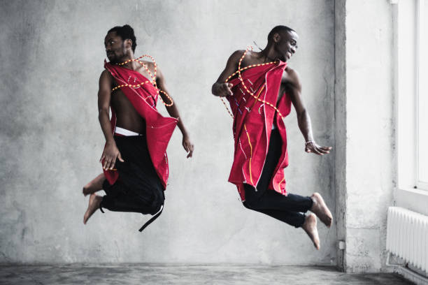 istock Two black young men in traditional costumes dancing in an empty room 1820216105
