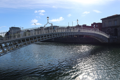 Dublin, Ireland – September 20, 2021: 19th century Ha'penny Bridge pedestrian bridge over the River Liffey from Ormond Quay Lower