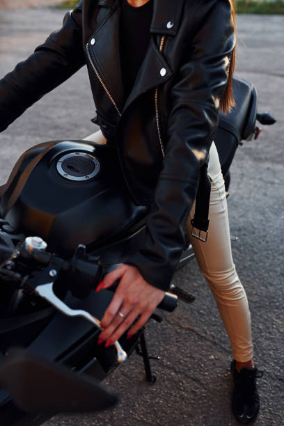 istock Woman is with motorcycle outdoors 1820247499