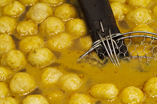 Chinese fish balls in soup with a ladle