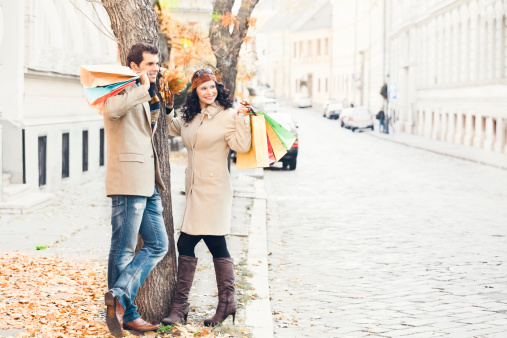 Happy couple holding shopping bagsSimilar images: