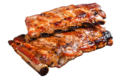 Stack of grilled pork ribs in BBQ sauce on a chopping board.  Isolated, white background
