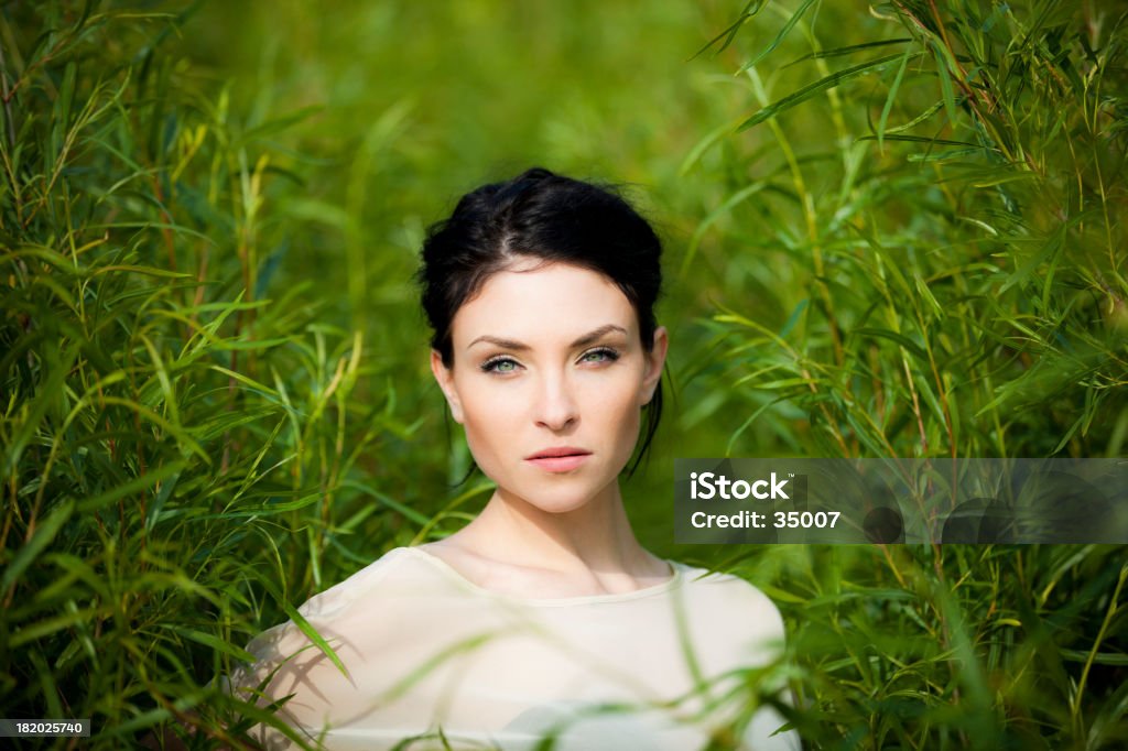 beauty in nature beautiful green eyed woman in green environment. 20-24 Years Stock Photo