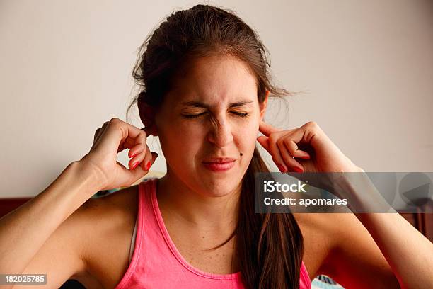 Young Woman Disturbed By Loud Noise Pollution Stock Photo - Download Image Now - Tinnitus, Earache, One Woman Only