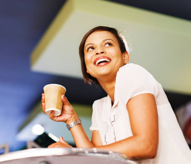 istock Beautiful smiling woman drinking coffee in cafe 182025834
