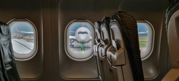 istock View from an airplane through the cabin windows onto another airplane in frontal view 1820259331