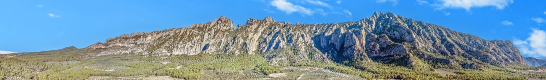 Drone panorama of the mountain range near the Monserrat monastery near Barcelona during the day in sunshine