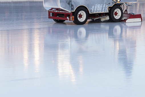 Ice rink polishing is in progress, machinery for ice renovation works on an empty arena