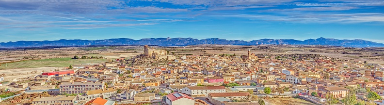 Drone panorama of the village of Almudevar in northern Spain with the Pyrenees in the background during the day
