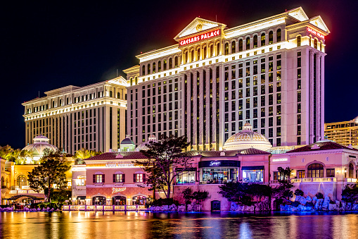 Las Vegas; USA; November 16, 2023: Photo of the fabulous Caesars Palace casino, hotel and resort on the Las Vegas Strip boulevard, reflecting in the Bellagio lake.