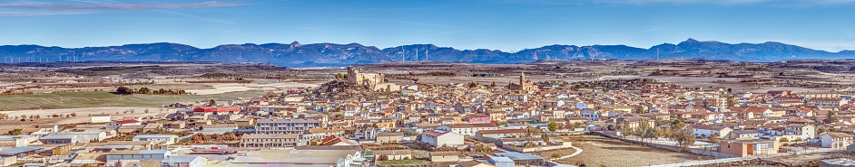 Drone panorama of the village of Almudevar in northern Spain with the Pyrenees in the background during the day