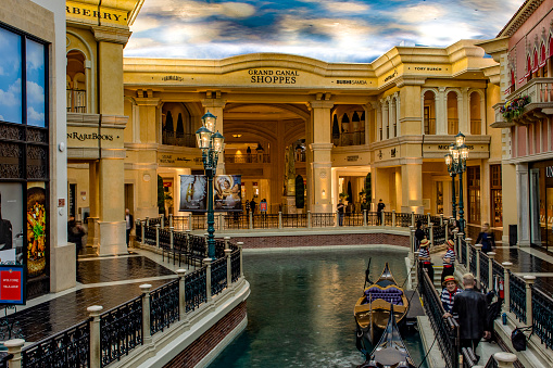 Las Vegas; USA; November 16, 2023: The grand Venetian canal with gondolas at The Venetian hotel on the Las Vegas Strip, this boulevard is lined with casinos, hotels and themed resorts for gambling.