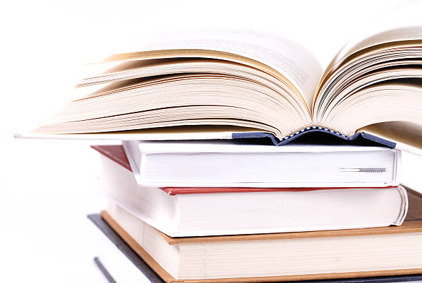 Stack of books with the book on top cracked open 