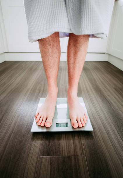 istock Checking his weight on the electronic weighing scale 1820263588