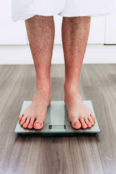 istock Checking his weight on the electronic weighing scale 1820264726