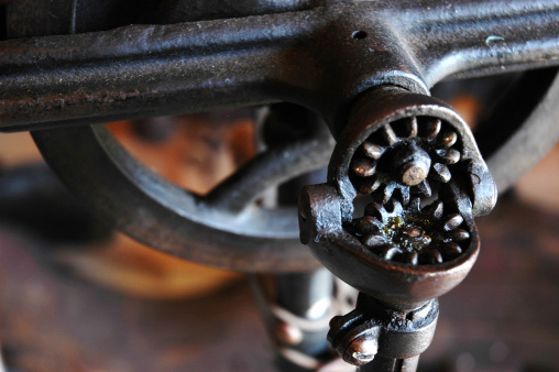 Close-up of an old hand-cranked corn peeling machine as decoration in a cozy loft living room. This photo was taken in a loft in the small village of Ambronay, in the Ain department in the Auvergne-Rhone-Alpes region in France.