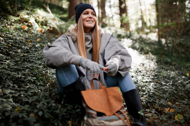 istock Young stylish female sitting in forest 1820267486