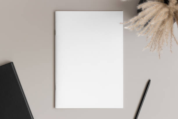 istock Magazine mockup with a pampas and workspace accessories on the beige table. 1820267528