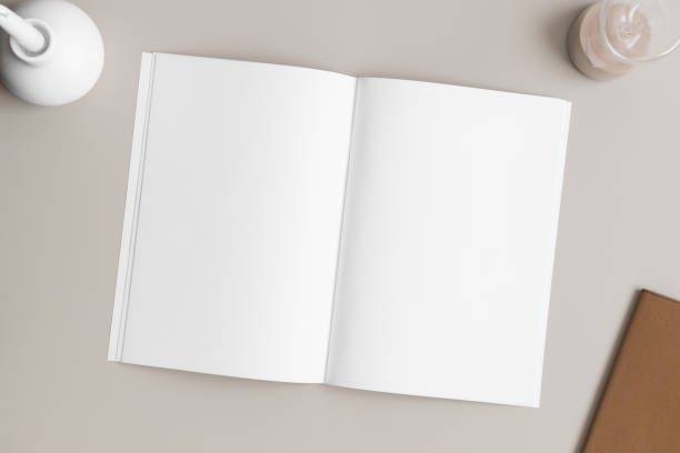 istock Open magazine mockup with a candle and workspace accessories on the beige table. 1820267529