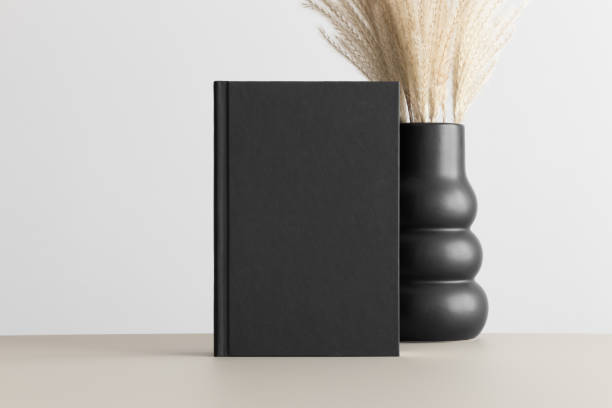 istock Black book mockup with a pampas decoration on the beige table. 1820267820