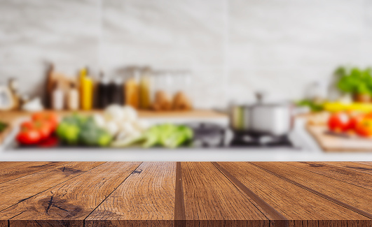 Wood table top on blurred kitchen background. can be used mock up for montage products display or design layout