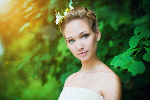 Outdoor portrait of a cute girl with flowers in hair stock photo