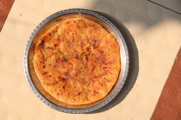 istock Aloo paratha or gobi paratha also known as Potato or Cauliflower stuffed flatbread dish. potato stuffed flat bread. North Indian famous food Aloo Paratha in isolated white background 1820276937