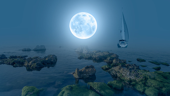 Lone yacht sailing on the sea with green moss on the rock - Super full moon in the background  