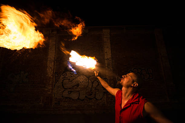 istock Street Performer Fire Breather Blowing on Torch 182028834