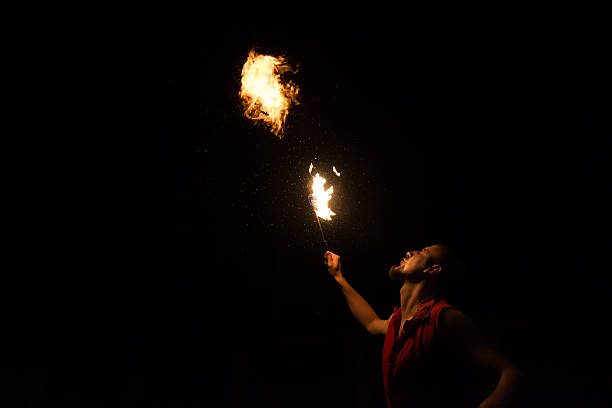 istock Street Performer Fire Breather Blowing on Torch 182028854