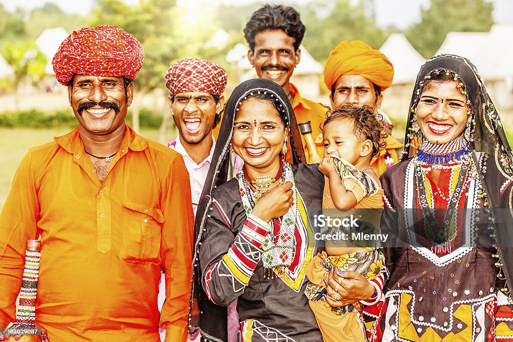 Indian Family Portrait Portrait of extended Indian family in traditional and ornate Indian clothing with headscarfs, saris and turbans. Indian real people, Pushkar, Rajasthan, India. Baby - Human Age Stock Photo