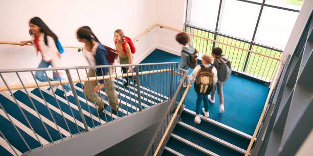 istock Group Of Secondary Or High School Pupils Inside School Building On Stairs With Motion Blur 1820291846