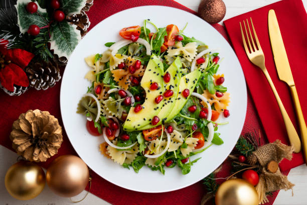 Argula salad with pasta bows, avocado, cherry tomatoes, pomegranate and sesame.