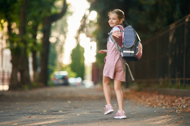 istock Schoolgirl with backpack is outdoors 1820298087