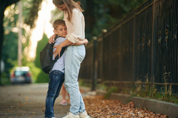 istock Woman with boy outdoors. Back to school conception 1820300580