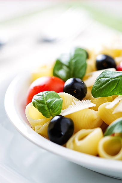 Pasta with fresh tomatoes and olives Pasta with fresh tomatoes and olives cooked selective focus vertical pasta stock pictures, royalty-free photos & images