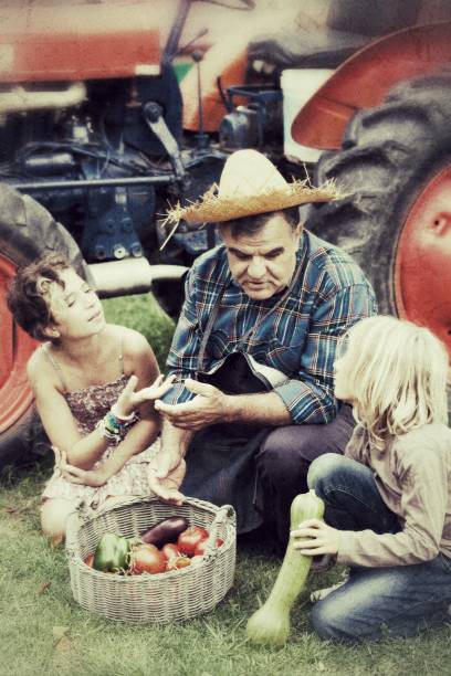 istock Farmer Man with Children in Countryside 182030351