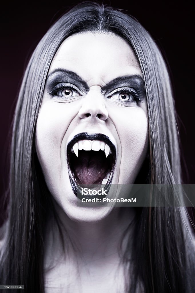 Vampire Beautiful female vampire showing off her fangs. Vampire Stock Photo