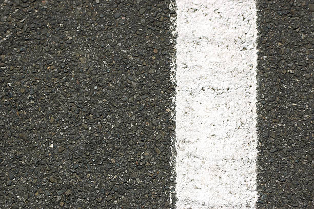istock Painted white line on bitumen sealed road 182030556