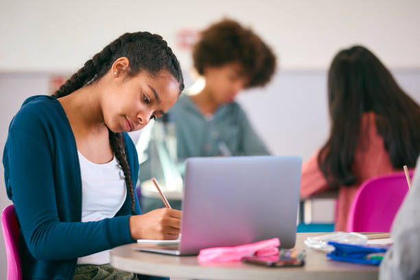 istock Female Secondary Or High School Pupil With Laptop Working In Study Area 1820309484