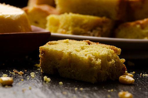 Slices of homemade cornbread and butter on kitchen table