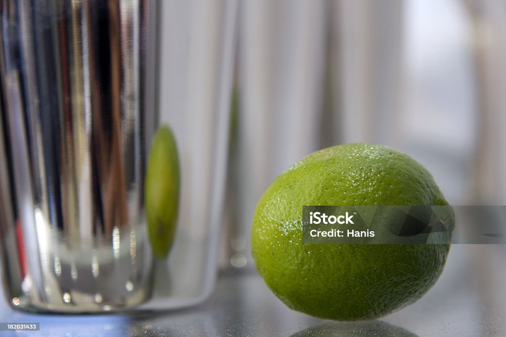 Lime in shaker Bar scene series - a lime reflecting in a shaker Alcohol - Drink Stock Photo