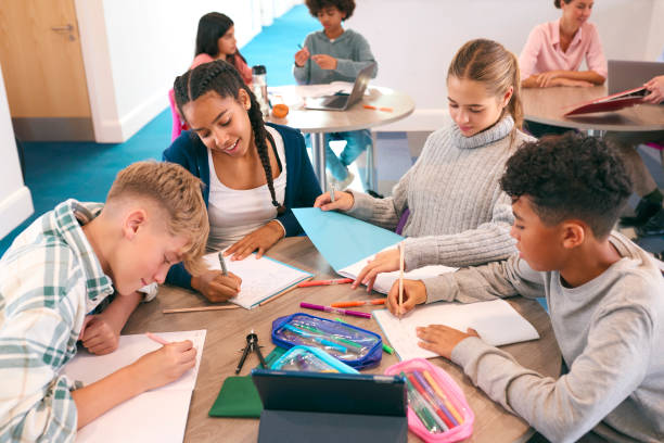 istock Secondary Or High School Students Collaborating In Study Area With Teachers In Background 1820317117