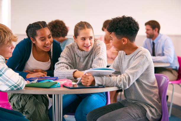 istock Secondary Or High School Students Collaborating In Study Area With Teachers In Background 1820321162