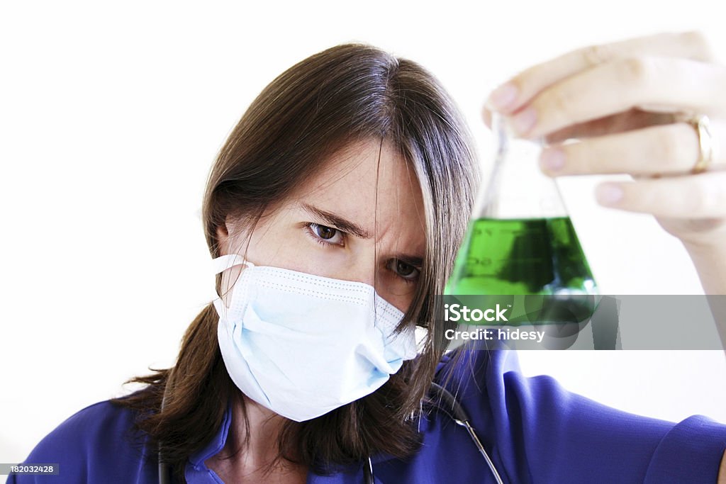 Hazardous Substance Scientist examines scary looking green substance.  Shallow depth of field with focus on face. Analyzing Stock Photo