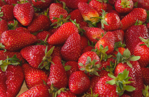 Ripe Strawberries in a colander washed and prepared for eating.